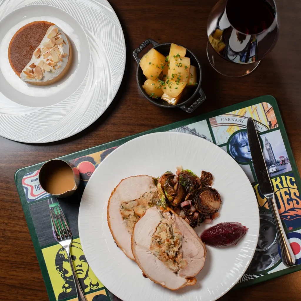Roasted turkey roulade with stuffing, Brussels sprouts, cranberry sauce and gravy, served with potatoes and dessert.